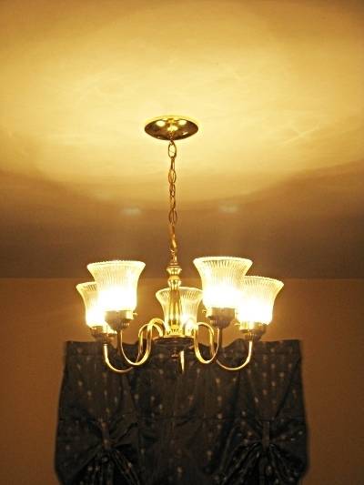 A chandelier has five votive lights on it.