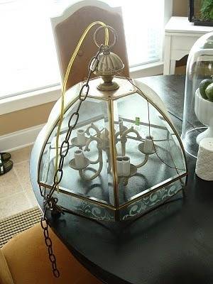 Antique-style ceiling lamp placed the end of a round table in an overall vintage setting