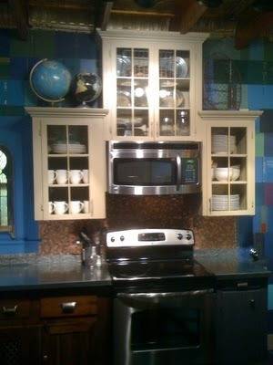 Cabinets surrounding a microwave over a stove.