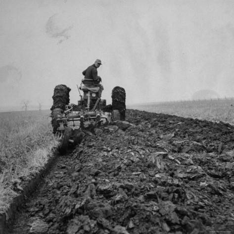 Farmer Plowing with a Tractor