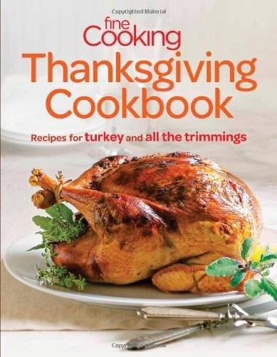 A Thanksgiving food cook book displays a cooked whole turkey on a platter.