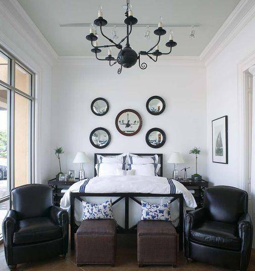 bedrooms - black chandelier brown black convex mirrors black iron bed black lattice nightstands brown nailhead trim ottomans black leather club chairs silver lamps blue pillows