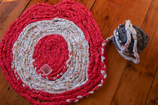 Colorful rug is placed on the wooden floor.