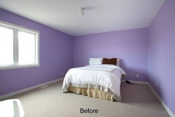 A violet coloured room with a bed.