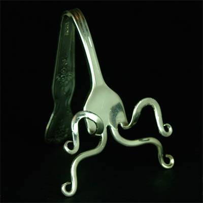 Stainless steel fork moulded like octopus.