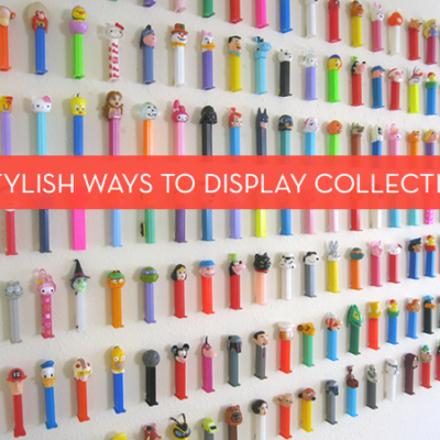 A collection of Pez dispensers are displayed on a wall.