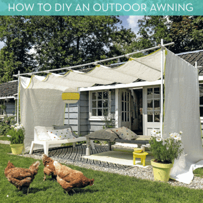 White fabric is draped over PVC piping in the backyard of a home in order to create an awning.