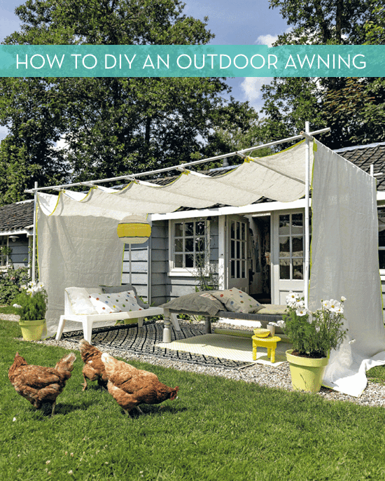 White fabric is draped over PVC piping in the backyard of a home in order to create an awning.