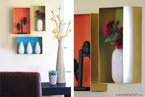 A number of vases and artworks in wall boxes.