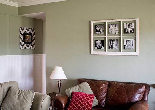Multiple photo frame on wall beside couch.