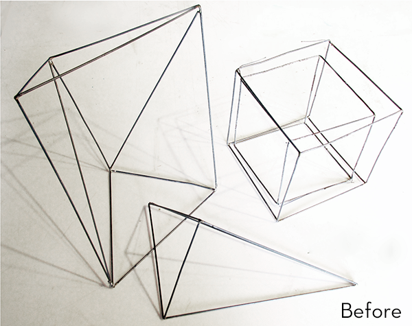 Cubes and pyramids shaped from metal wire.