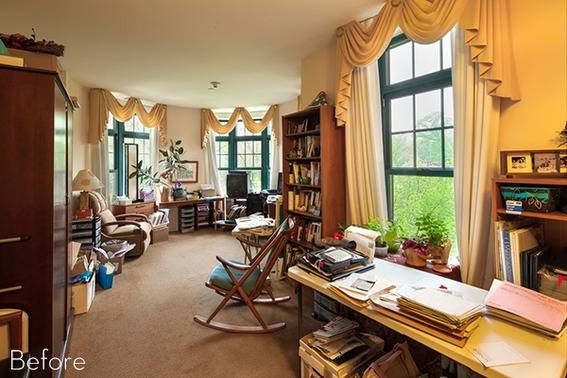 A light-filled room with furnishings and books.