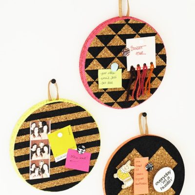 Three round cork and leather hanging memo boards.