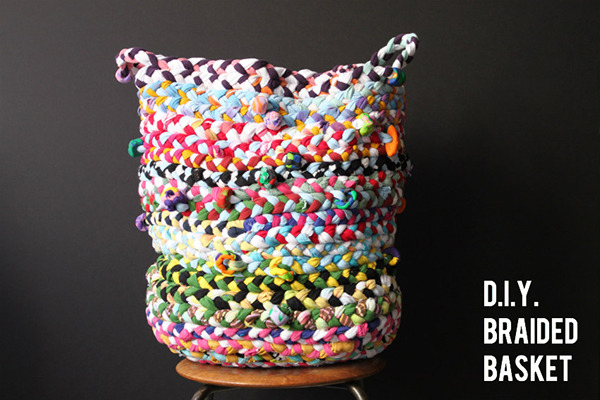 A colorful braided basket sitting on a chair.