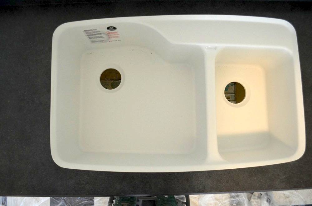 A sink that needs to be hooked up, with two basins.