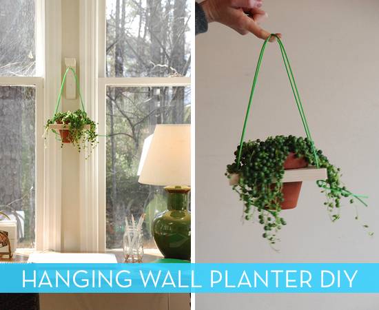 A wall planter on the wall and one held by a hand.
