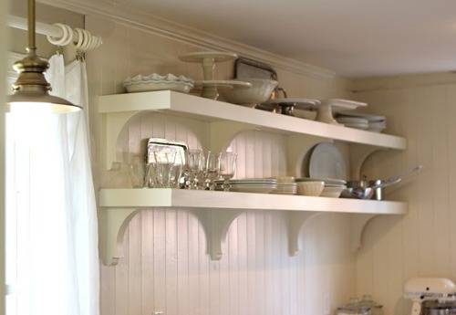 Two shelves for serving items in a kitchen.