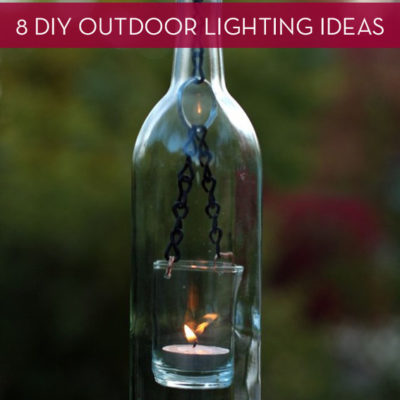 A hanging glass bottle with a tea light in it.