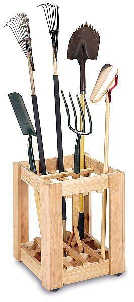 A wooden container holds various garden tools.