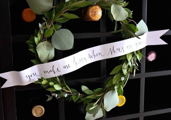 A handmade wreath with a ribbon across it.
