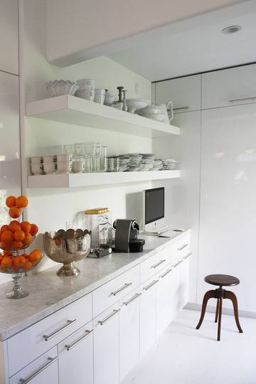 White, organized kitchen counters in a very white kitchen.