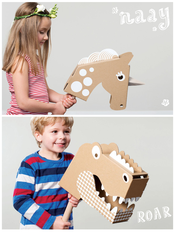 Kids playing with cardboard animals.