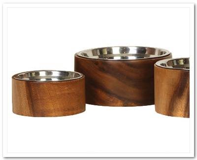 Three silver bowls in wooden holders.