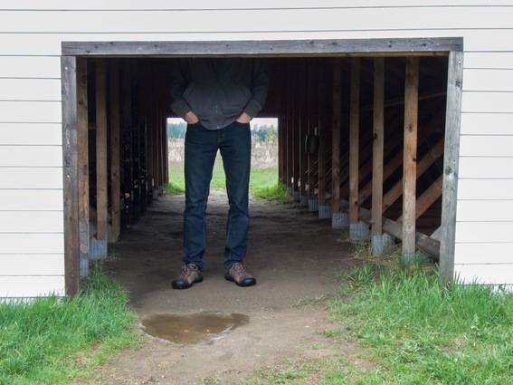 A man is standing under an area with a low doorway.