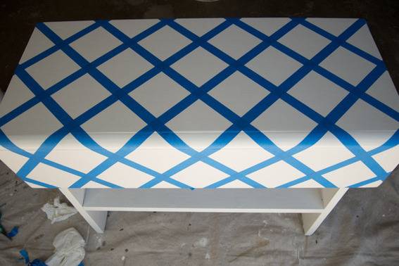 Wood rustic bench with painters tape in a diamond design.