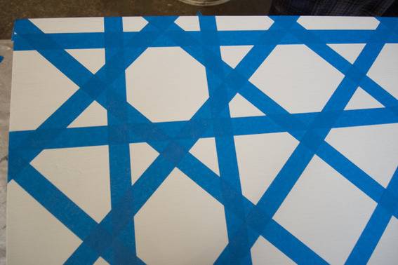 A floor with a blue and white pattern of crossing lines.