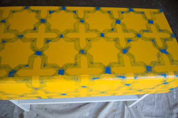 Yellow and blue wrapping paper covers a white shelf.