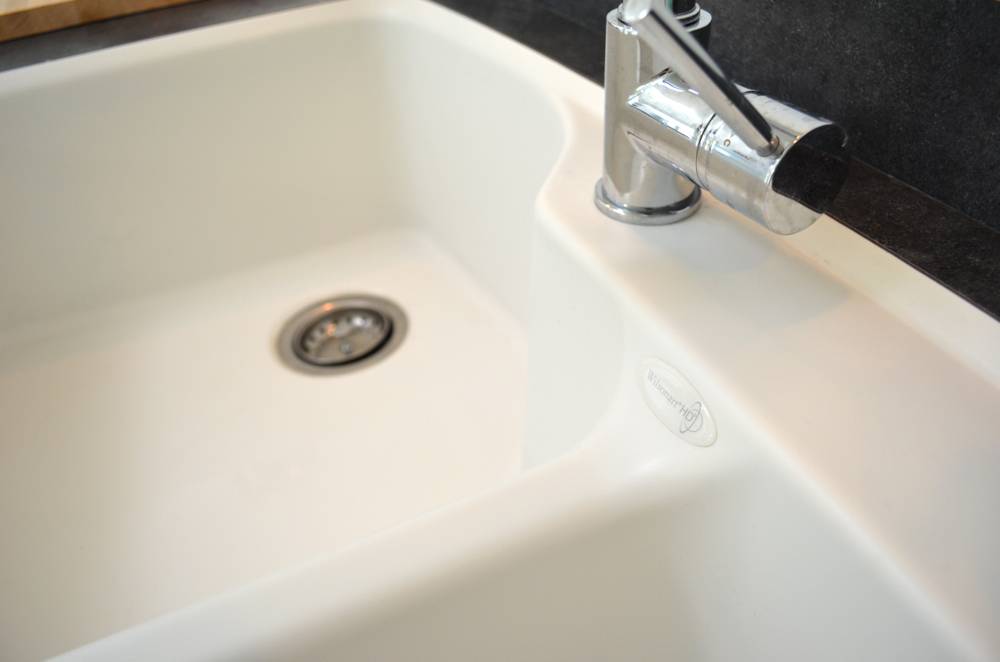 A white sink has two basins.