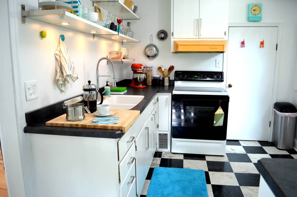 A kitchen with a black and white checkered floor.