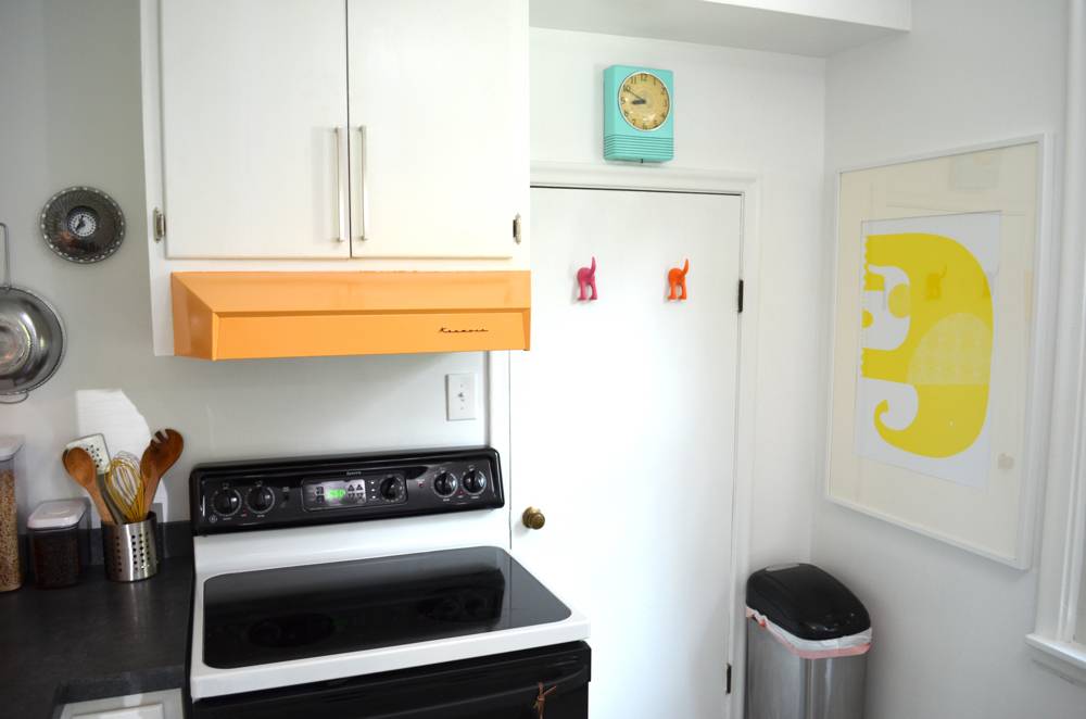 A basic kitchen with stove and cabinets being shown.