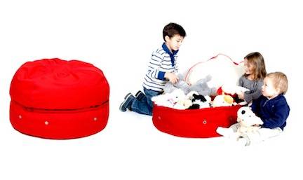 Kids around beanbag full of stuffed toys.