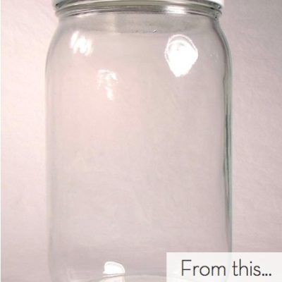 An empty glass jar has a white background.