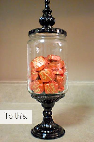 A glass container has orange candy in it.