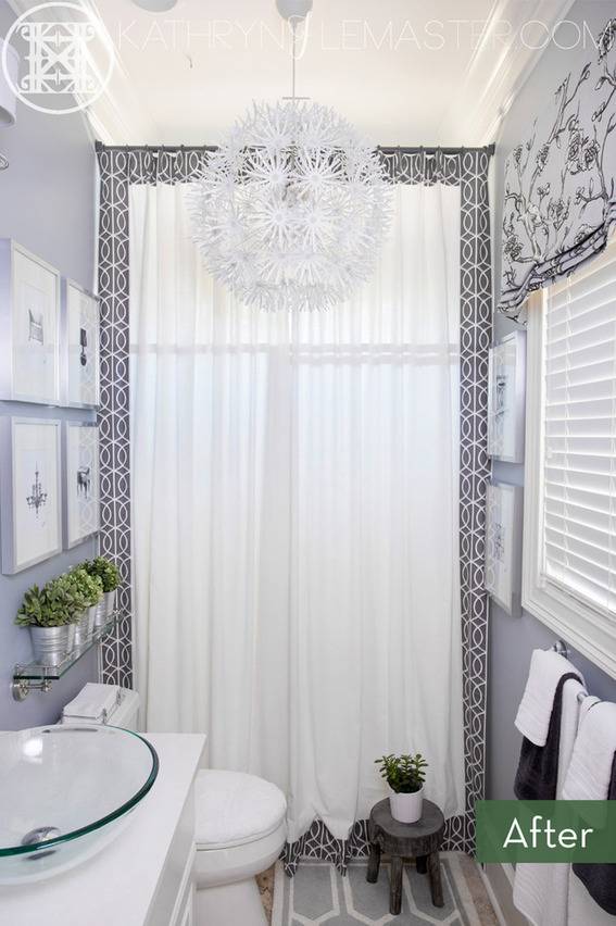 A bathroom that is all white and blue, with a large window in the back.