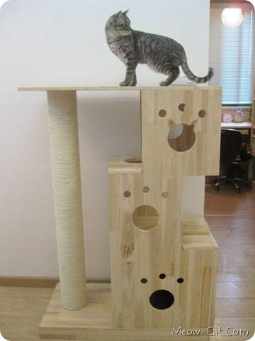 A cat tree made up of wooden boxes and a pole.