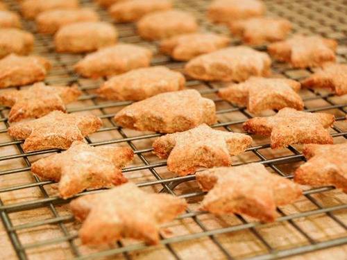 Starfish cookies sitting on a baking rack.