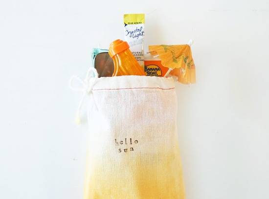 A cloth shopping bag that has various bits of food sticking out of it.