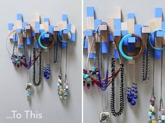 Blocks of wood shaped into jewelry holder with necklaces hanging from hooks.