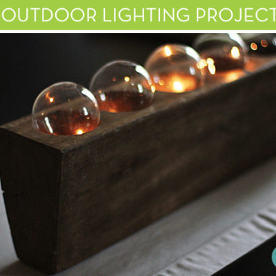 Group of glass light bulbs in a wood tray.