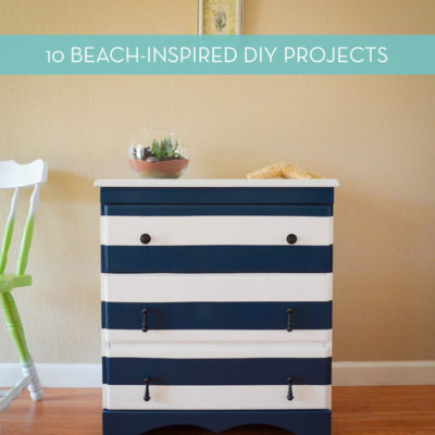 A black and white horizontally striped dresser. with a succulent in a pot on top.