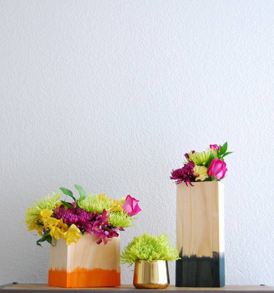 Wood blocks dyed to look like pots, with flowers in them.