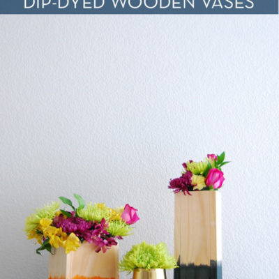 Flowers in a dye dipped wooden vase in a living room.