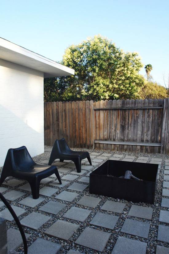 outdoor patio with black chair and a firewood place