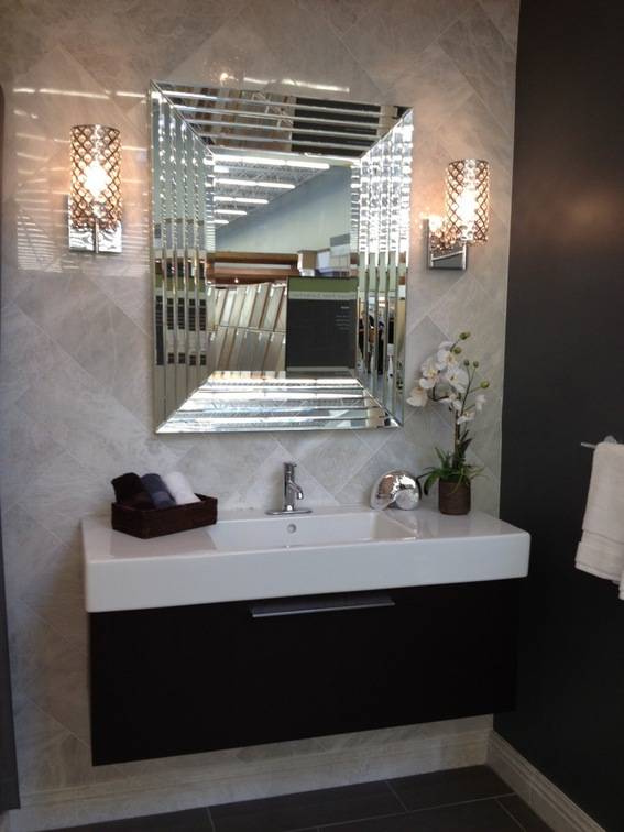 A fancy bathroom sink with an elaborate mirror.