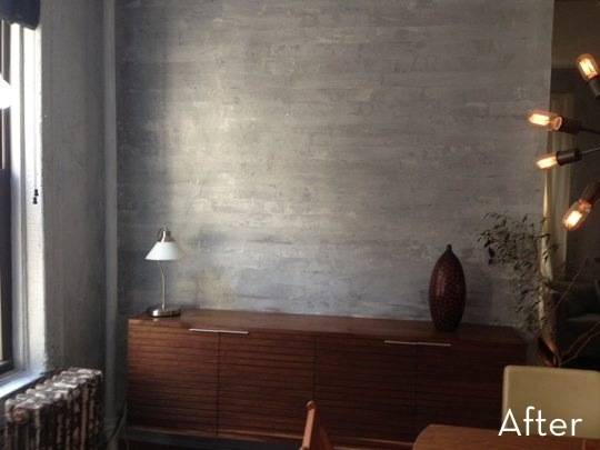 A wooden sideboard is set in a room with a silver wall.