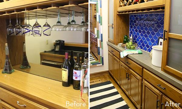 A kitchen area that has bottles of wine and glasses.